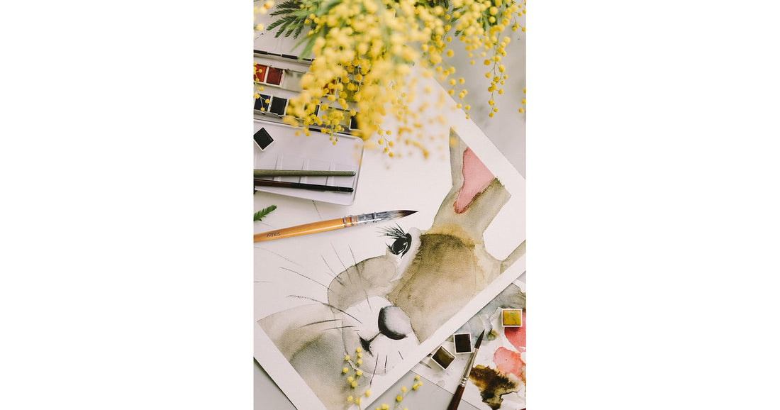 Delicate watercolor painting of a rabbit surrounded by flowers on cold press paper